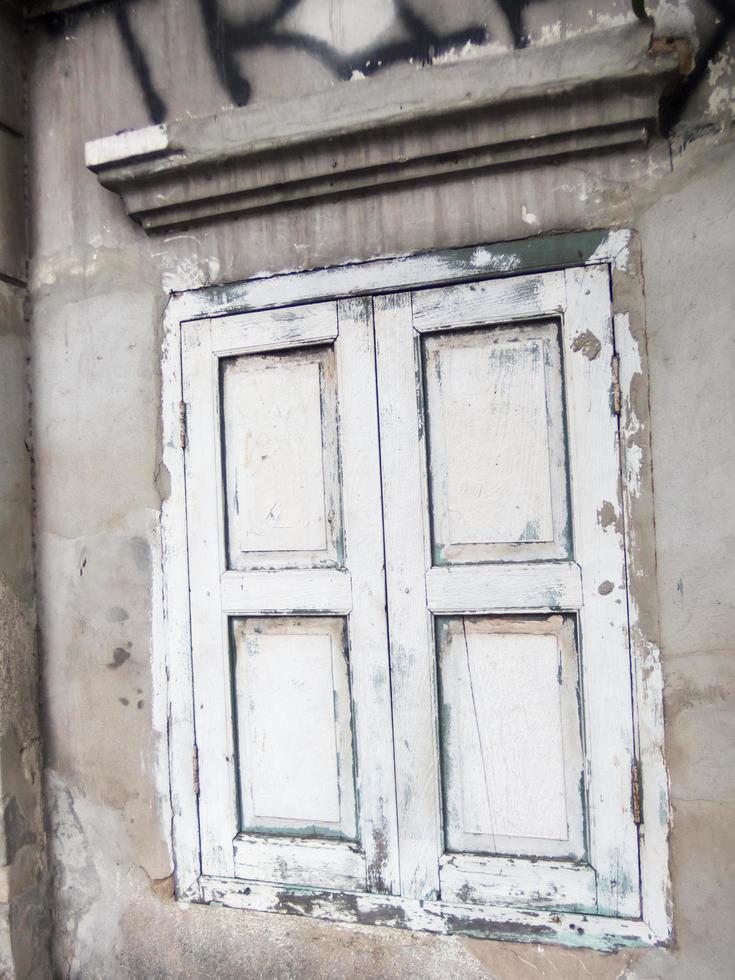 Ancient abandoned buildings with wooden doors and windows. photo