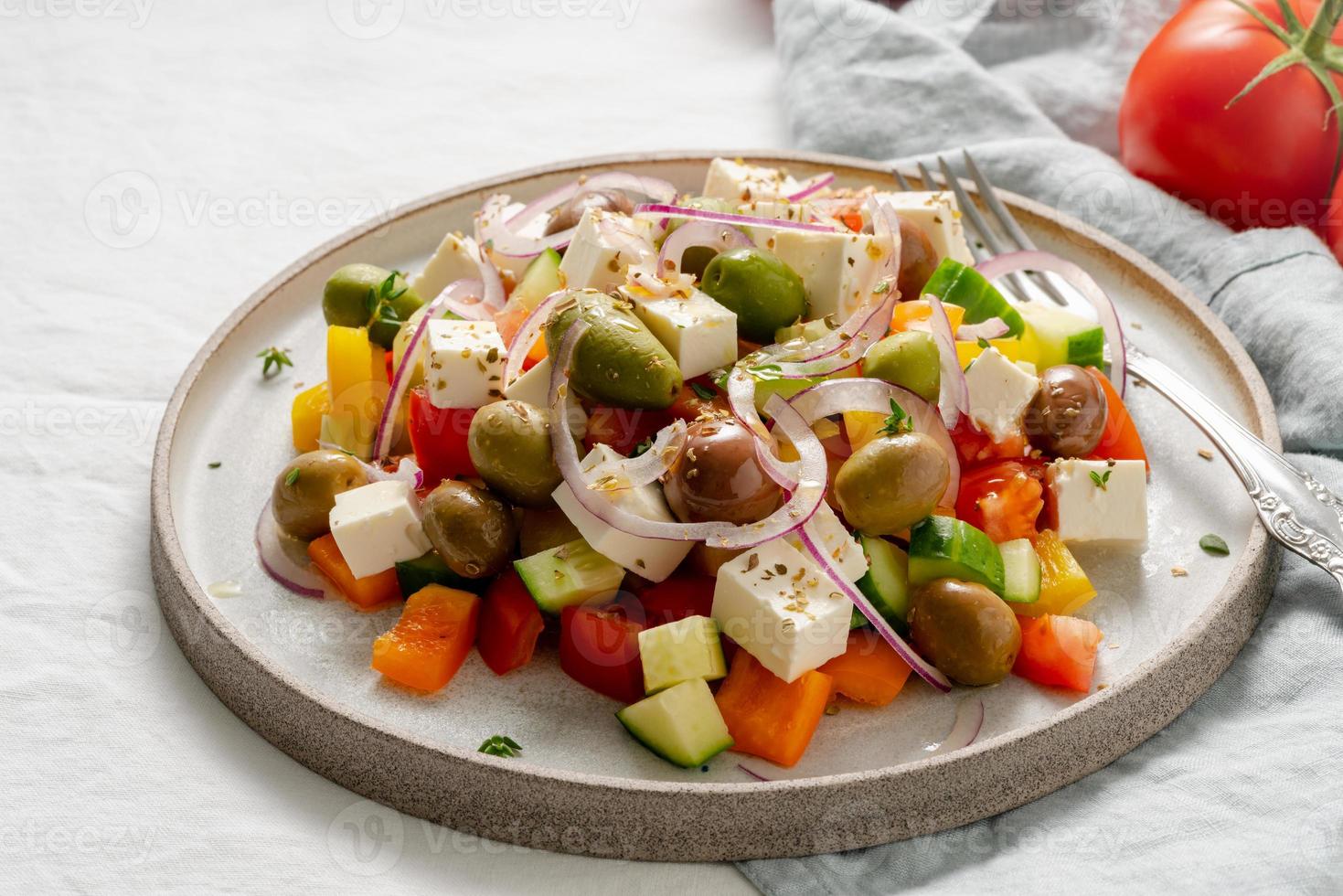 Greek village salad horiatiki with feta cheese and vegetables, vegeterian mediterranean food photo