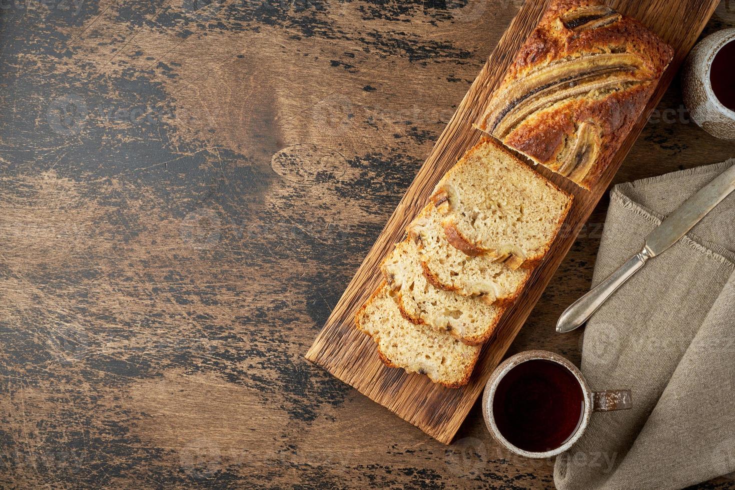 Banana bread. Cake with banana, traditional american cuisine. Slices of loaf. Dark background photo