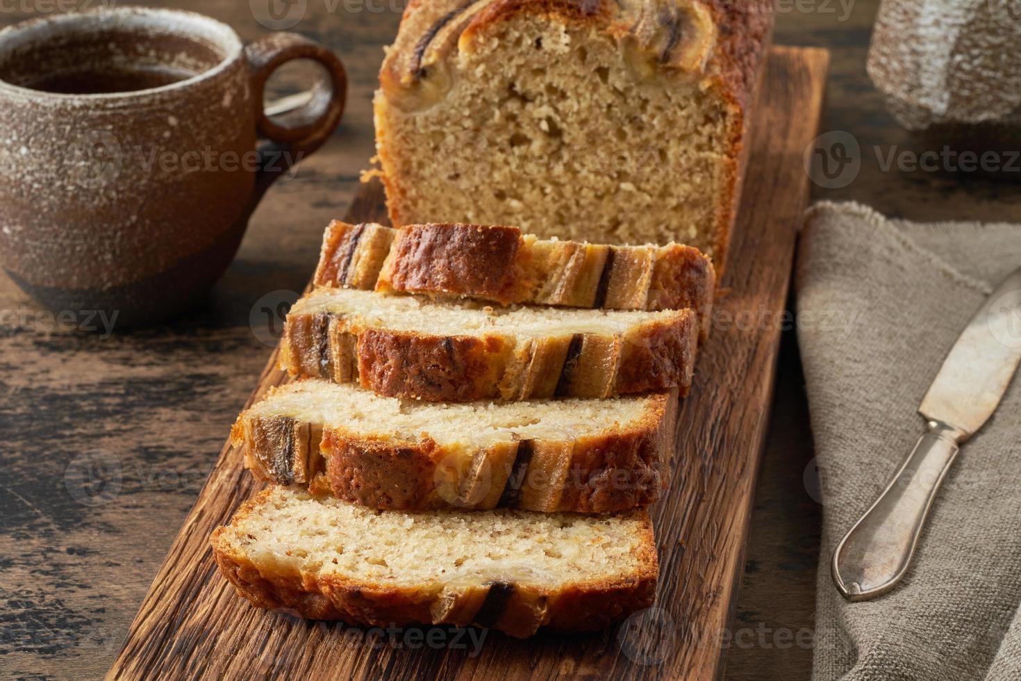 Banana bread. Cake with banana, traditional american cuisine. Slices of loaf. Dark background photo