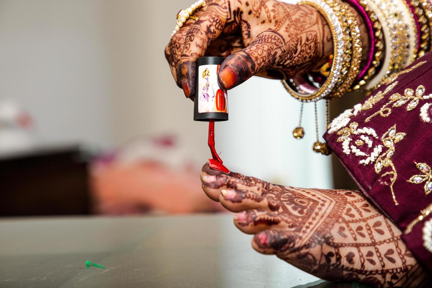 Low section of Bride applying Nail polish photo