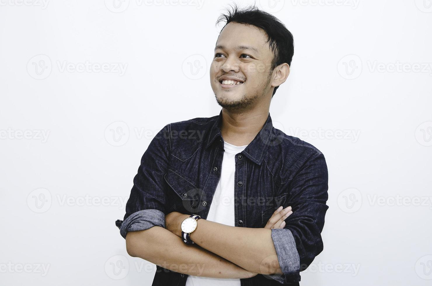 Portrait of smiling young asian man wearing white shirt and denim pant isolated on white. photo