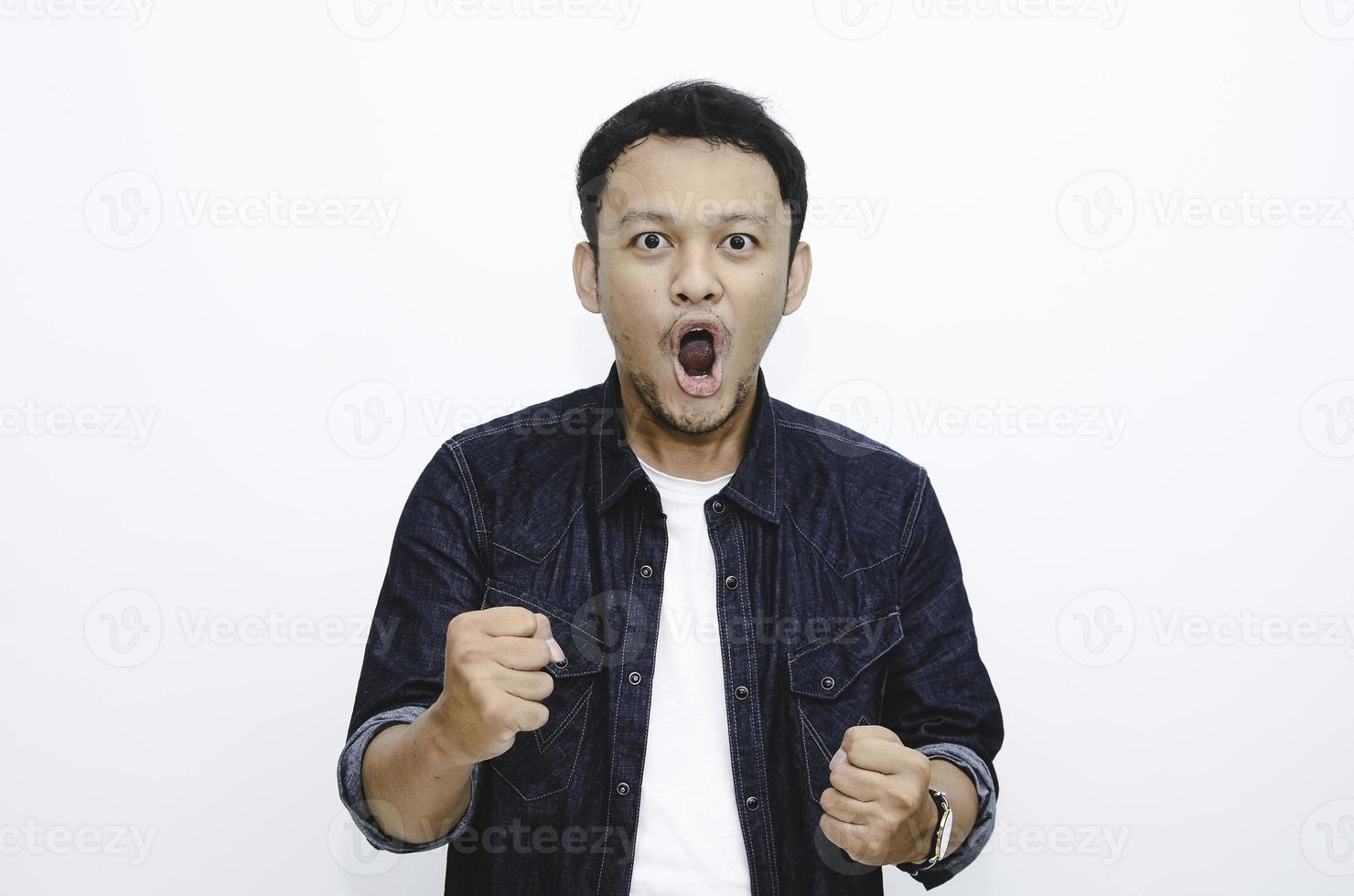 Wow and shocked face of Young Asian man with open hand gesture. Advertising model concept. photo