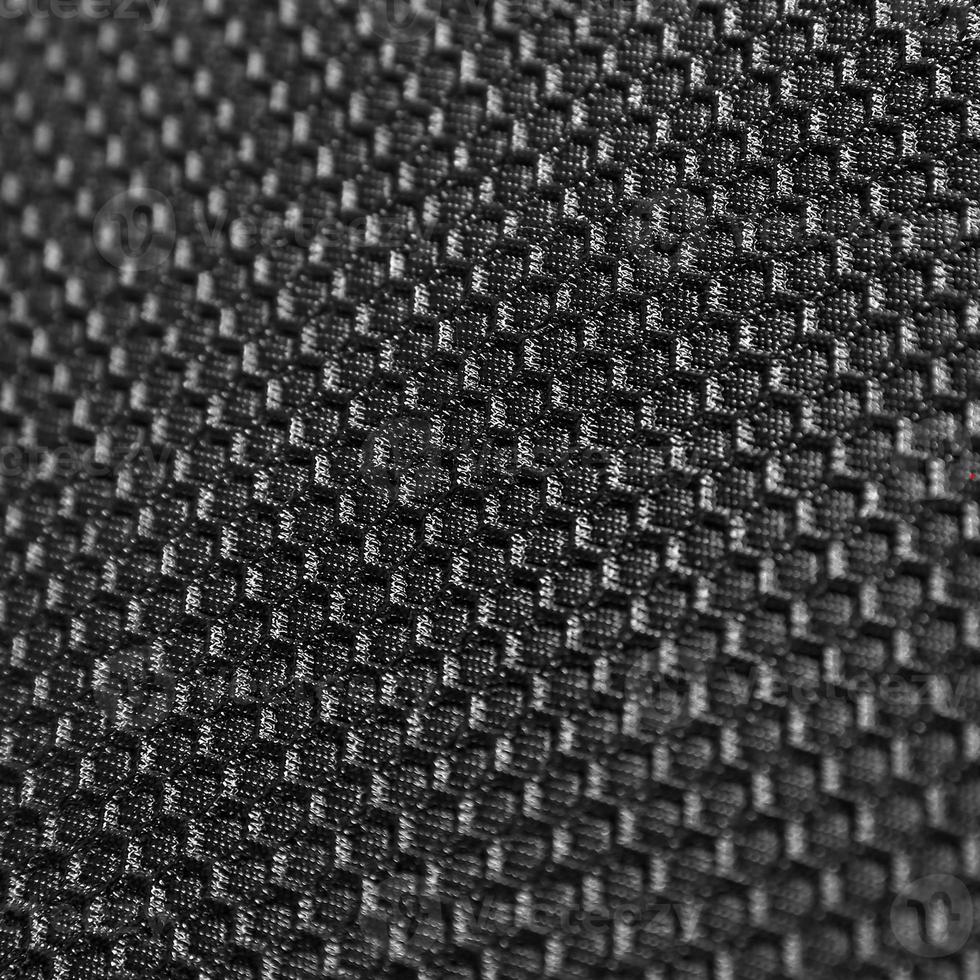 Texture of black leather background with honeycomb shape pattern, macro photo