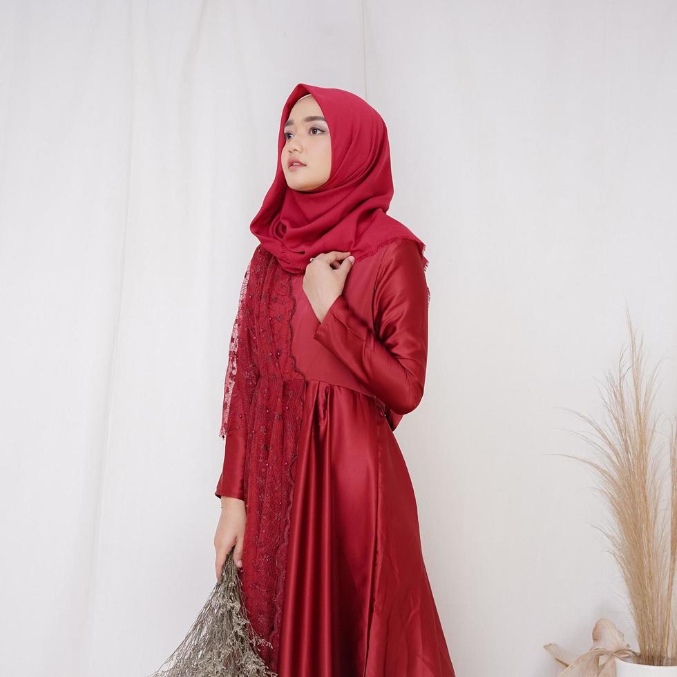 Beautiful islamic female model wearing hijab fashion, a modern lifestyle outfit for muslim woman. Concept a wedding dress, beauty or eidul fitri. A asian girl model wearing hijab on indoor photoshoot photo