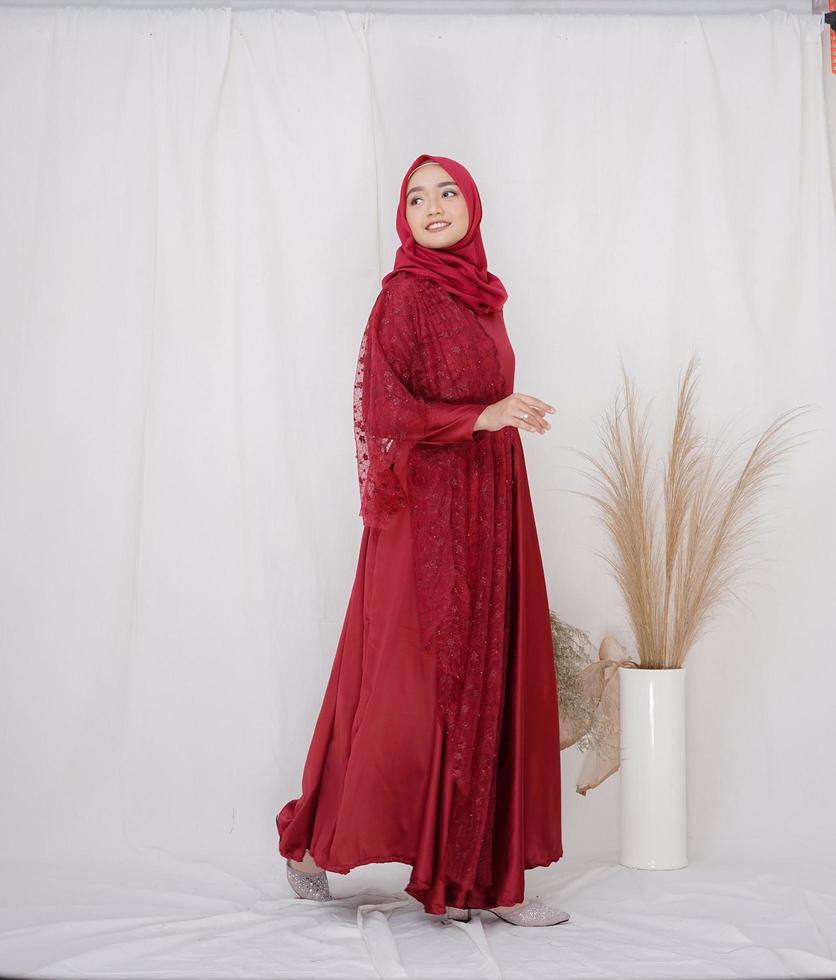 Beautiful islamic female model wearing hijab fashion, a modern lifestyle outfit for muslim woman. Concept a wedding dress, beauty or eidul fitri. A asian girl model wearing hijab on indoor photoshoot photo