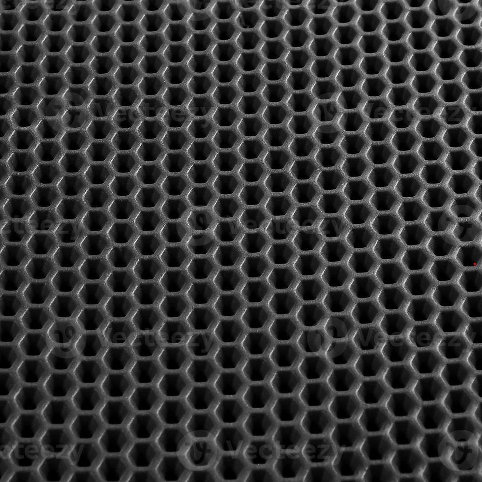 Texture of black leather background with honeycomb shape pattern, macro photo