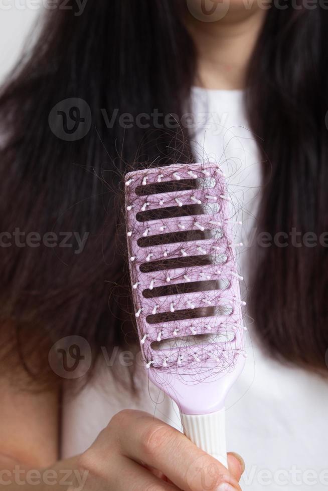 Comb with lost hair. Tangled and falling out hair, care for long hair concept photo