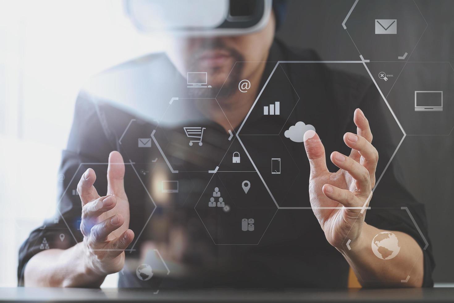 businessman wearing virtual reality goggles in modern office with mobile phone using with VR headset with screen icon diagram photo