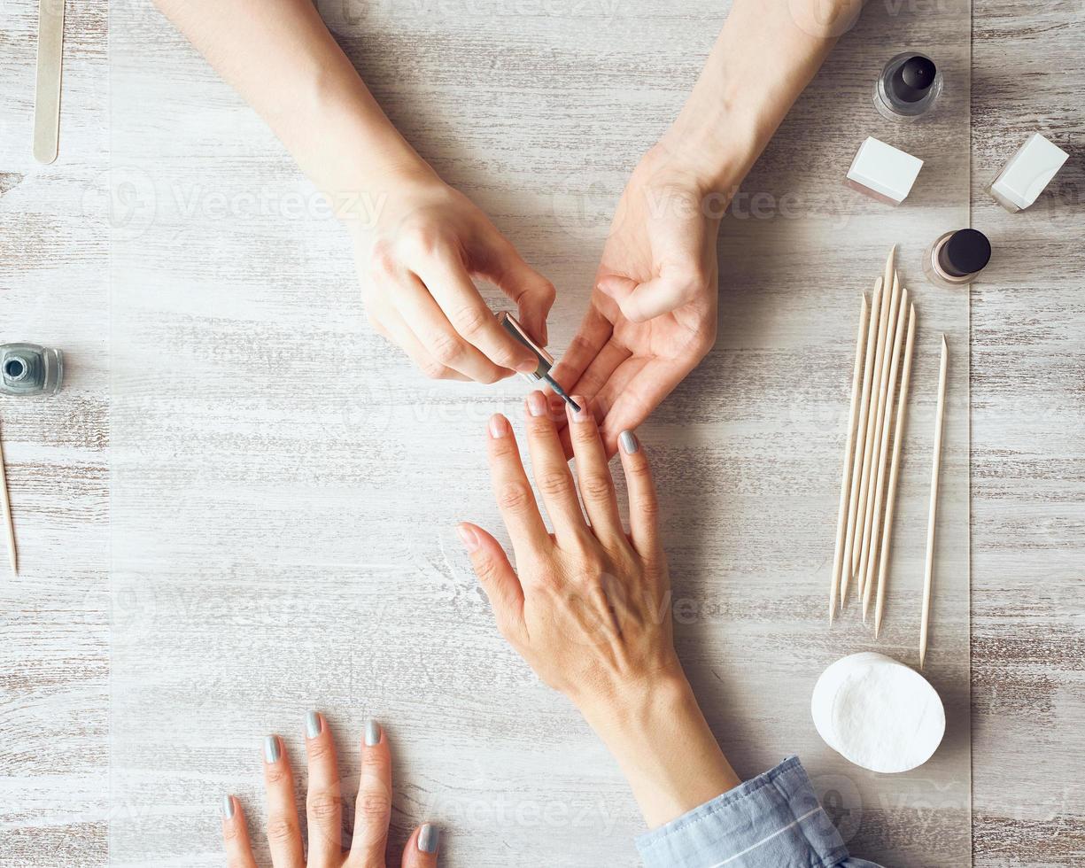 madre e hija hacen manicura, pintan uñas con barniz. autocuidado en el hogar durante la cuarentena foto