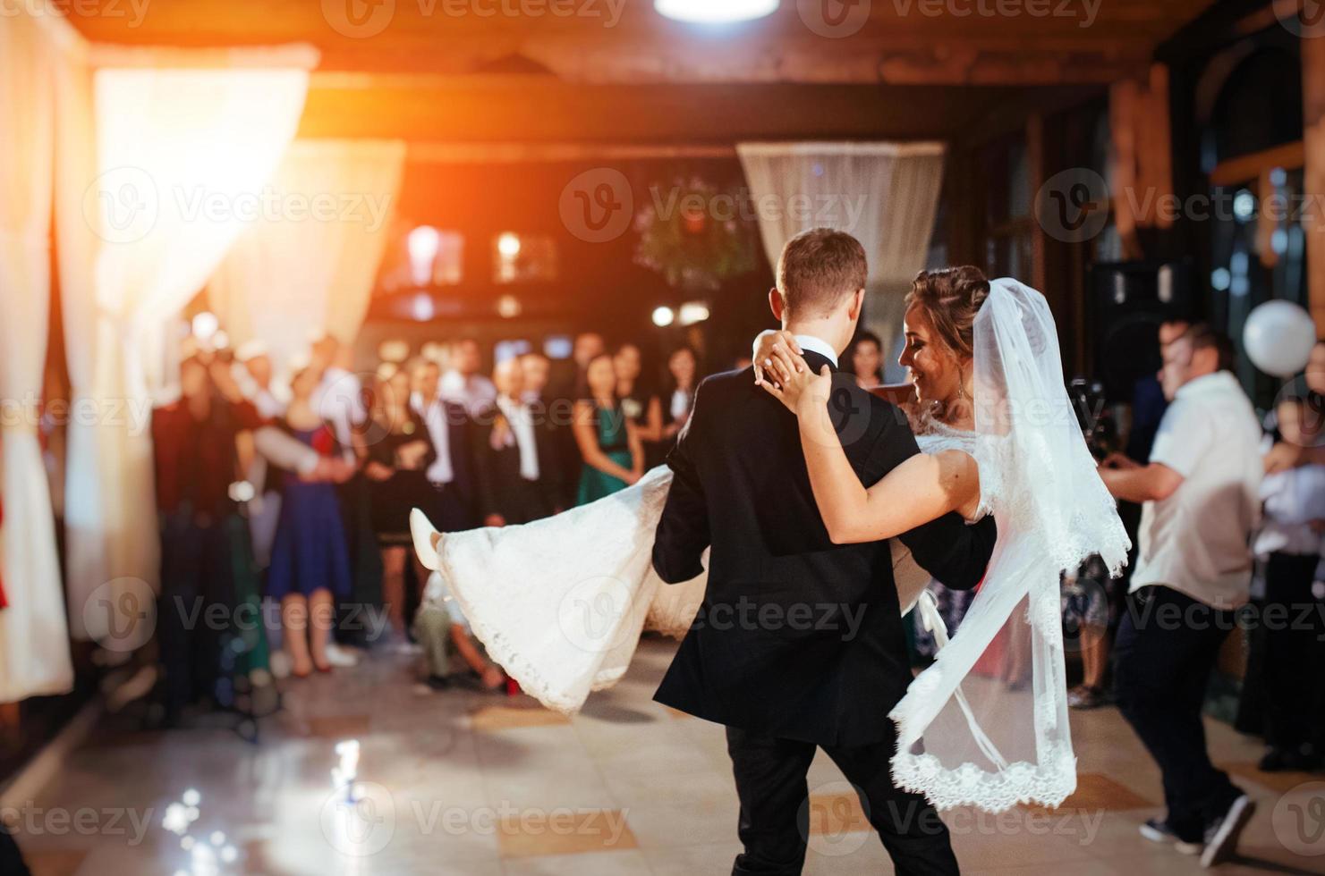 Happy bride and groom a their first dance, wedding photo