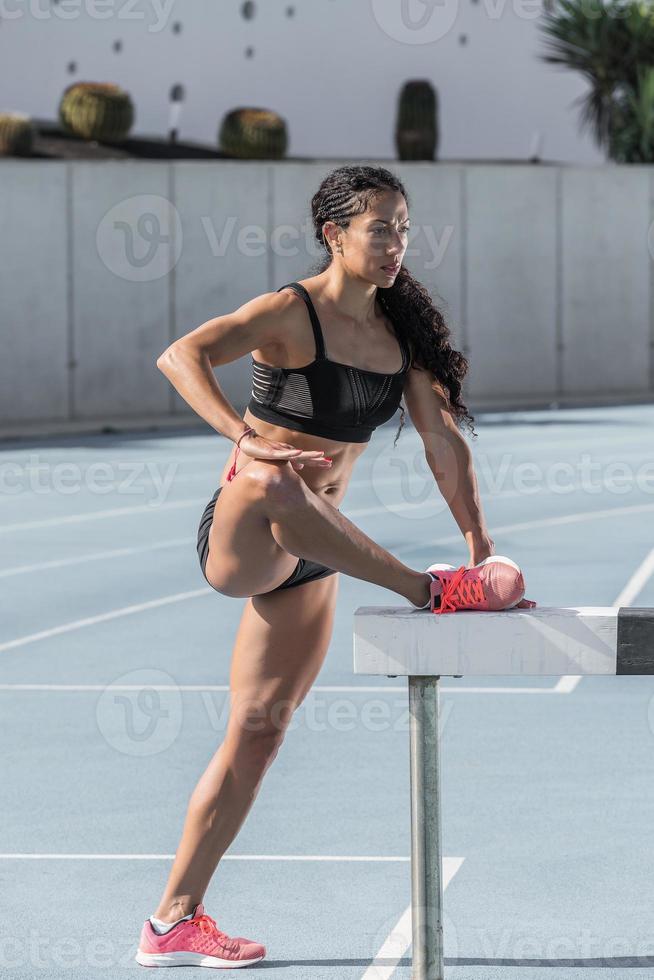 Athlete performing stretching exercises photo