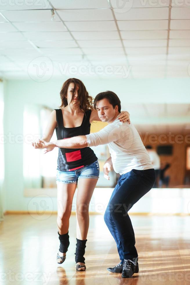 Beautiful couple of professional artists dancing passionate danc photo