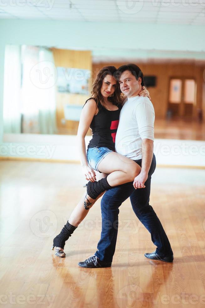 Beautiful couple of professional artists dancing passionate danc photo