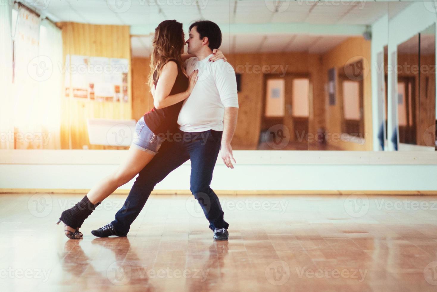 Beautiful couple of professional artists dancing passionate danc photo