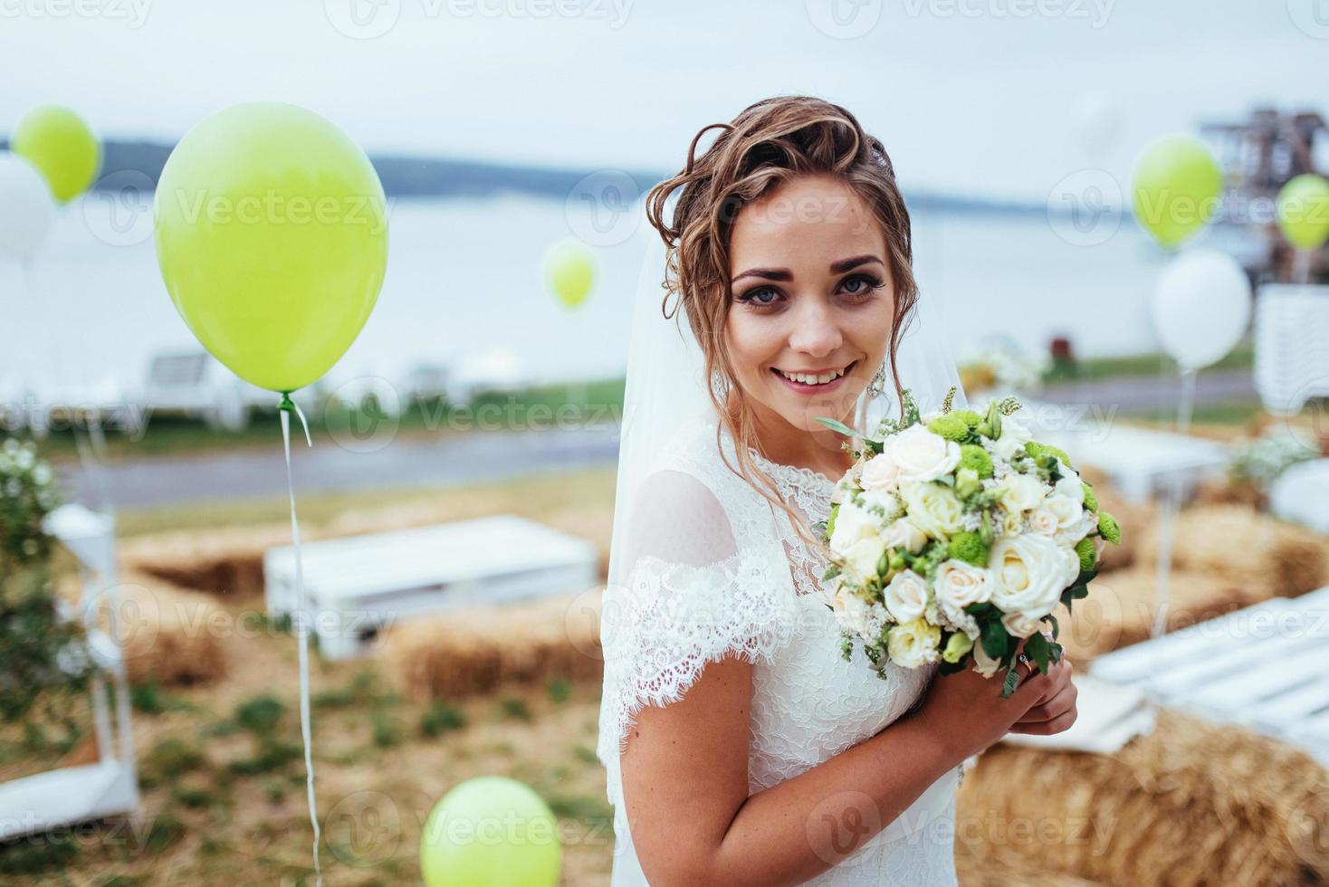 Beautiful brunette bride in a white dress at wedding photo