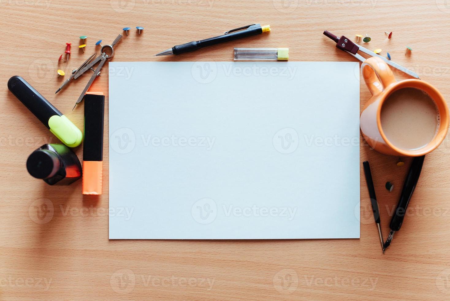 white empty sheet with lots of stationery objects makes photo