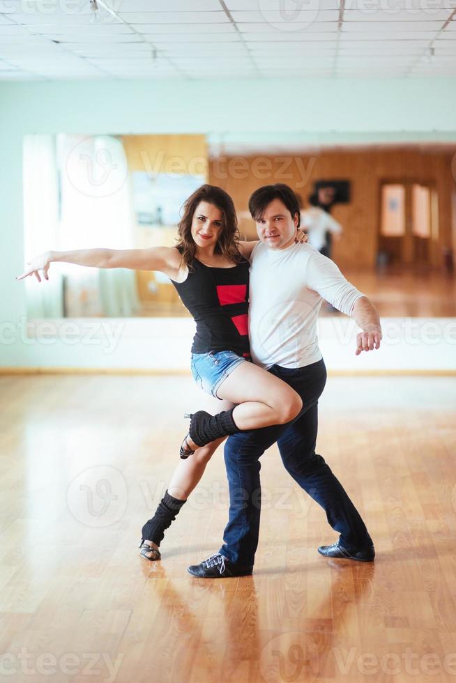 Beautiful couple of professional artists dancing passionate danc photo