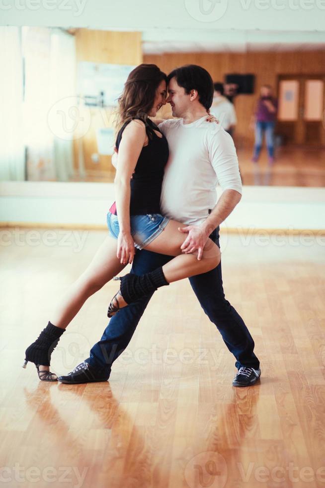 Beautiful couple of professional artists dancing passionate danc photo