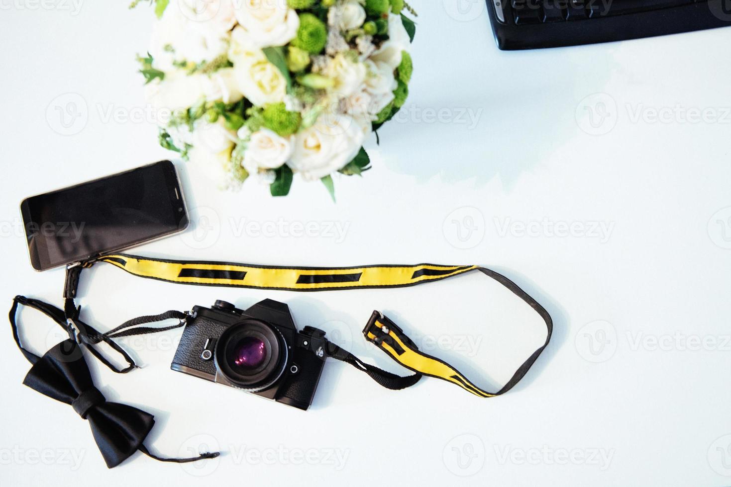 Photo retro camera on a table with different objects