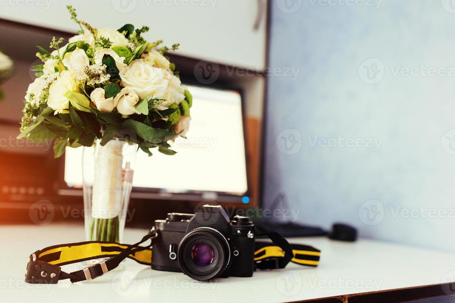 Photo retro camera on a table with different objects