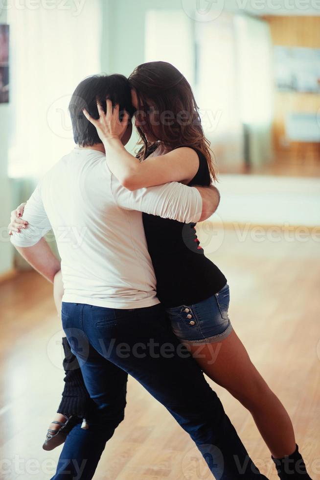 young couple dancing on the roof of a tall building photo