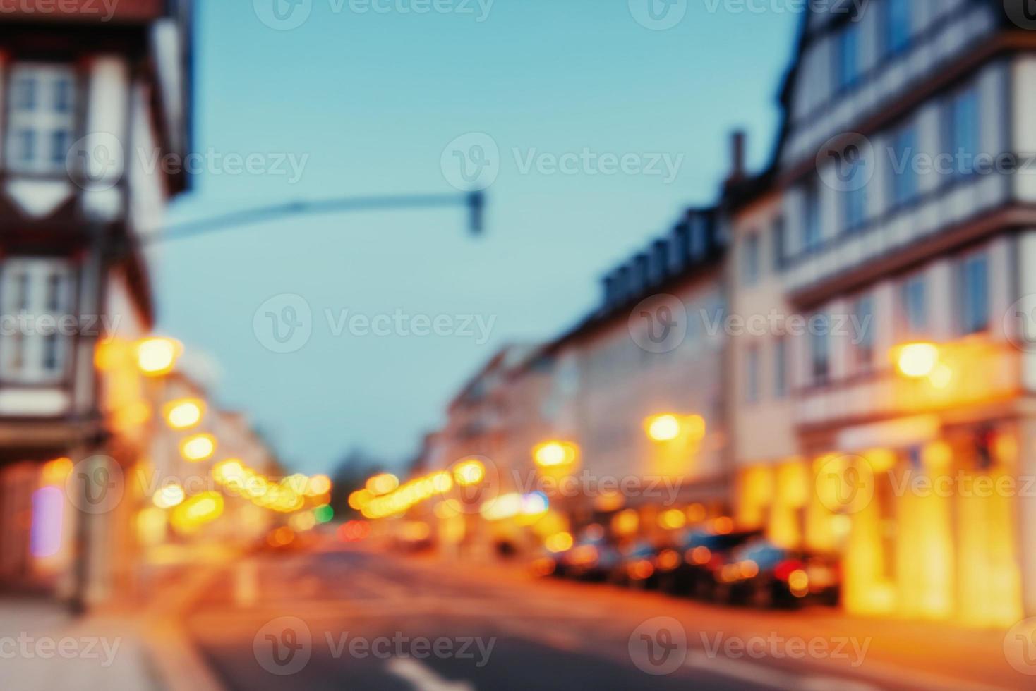 Cars parked along cobblestone way. Natural blurred background. S photo