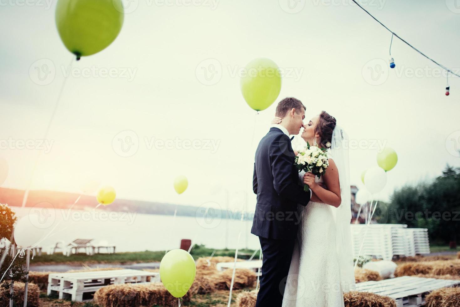 Beautiful young couple kissing wedding, blonde bride with her gr photo