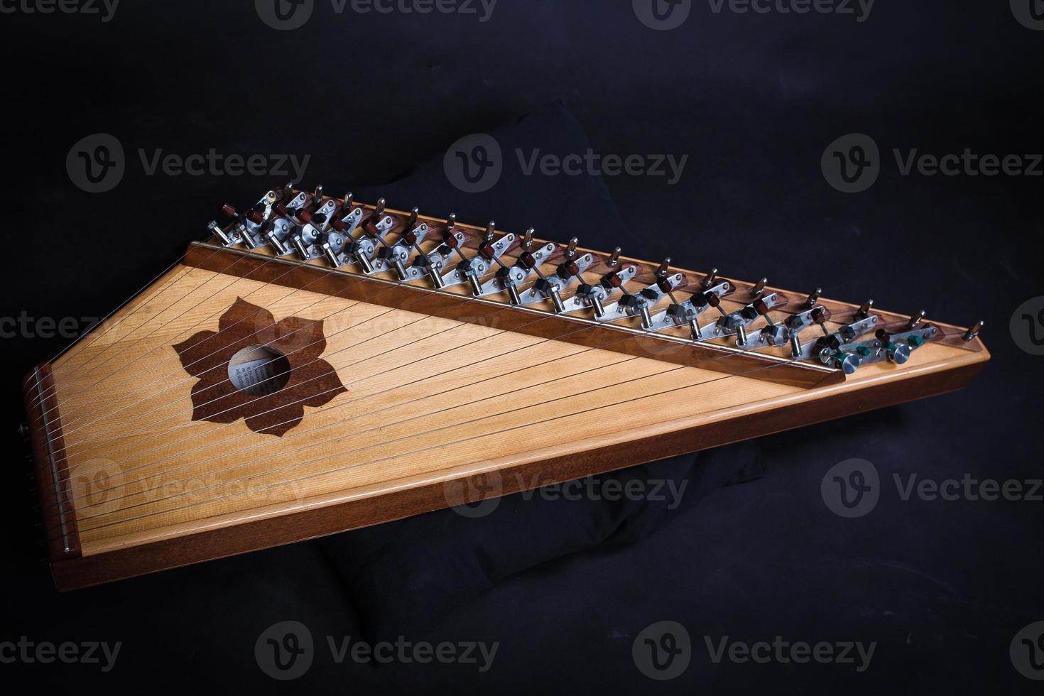 Russian folk musical instruments. Gusli isolated on a black background photo