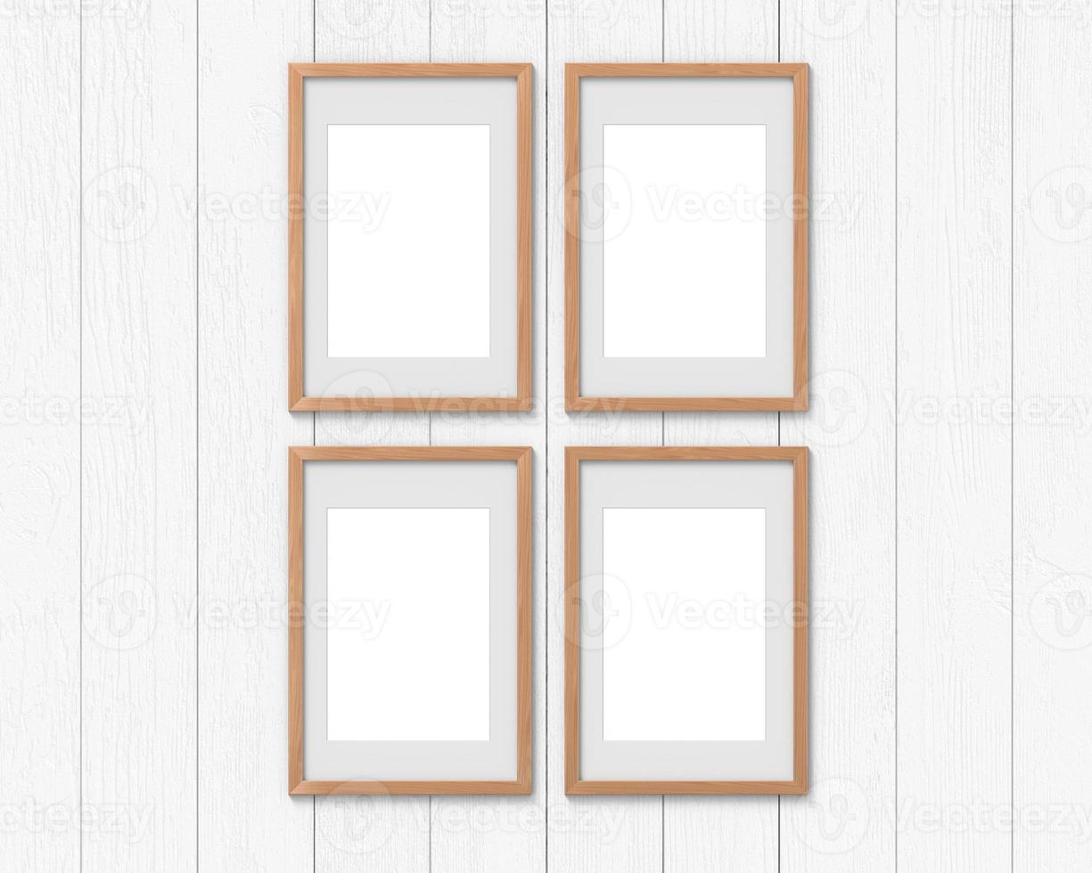 Set of 4 vertical wooden frames mockup with a border hanging on the wall. Empty base for picture or text. 3D rendering. photo