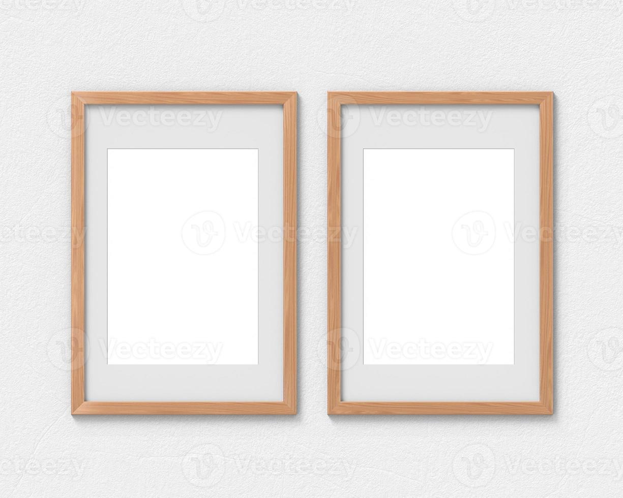 Set of 2 vertical wooden frames mockup with a border hanging on the wall. Empty base for picture or text. 3D rendering. photo