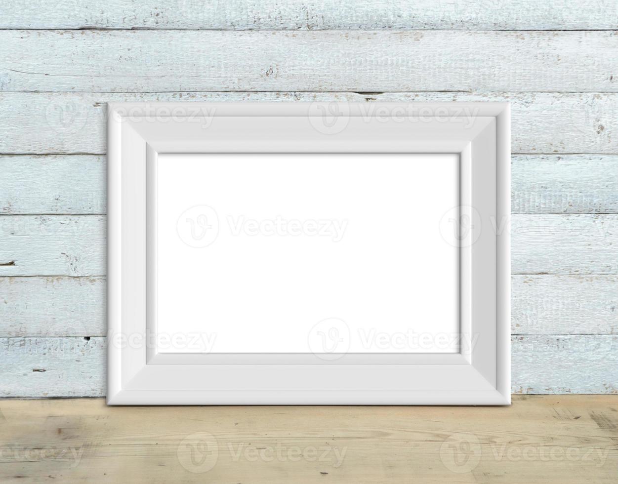 Old horizontal A4 White Wooden Frame mockup stands on a wooden table on a painted white wooden background. Rustic style, simple beauty. 3d render. photo