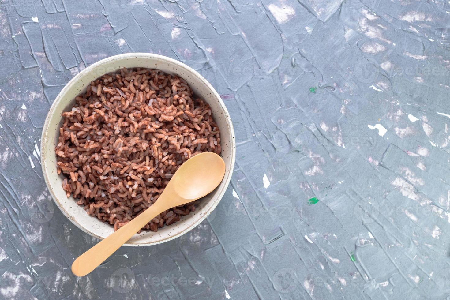 Rice red in bowl isolated on grey background. Asian food cooked. photo