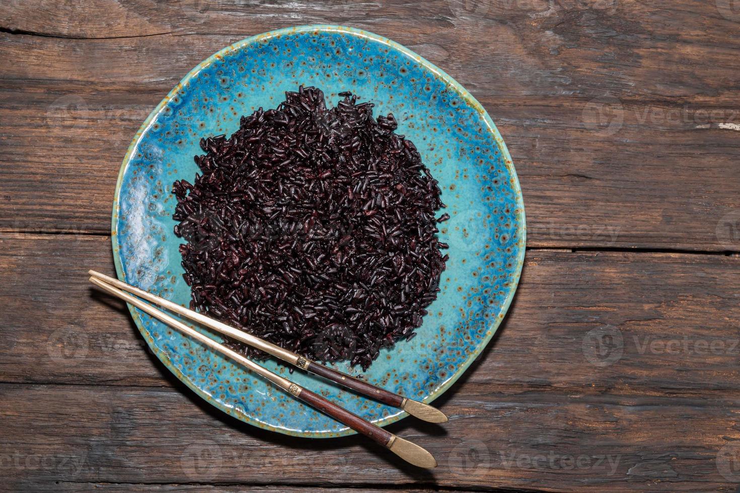 Healthy food black rice in blue plate. photo