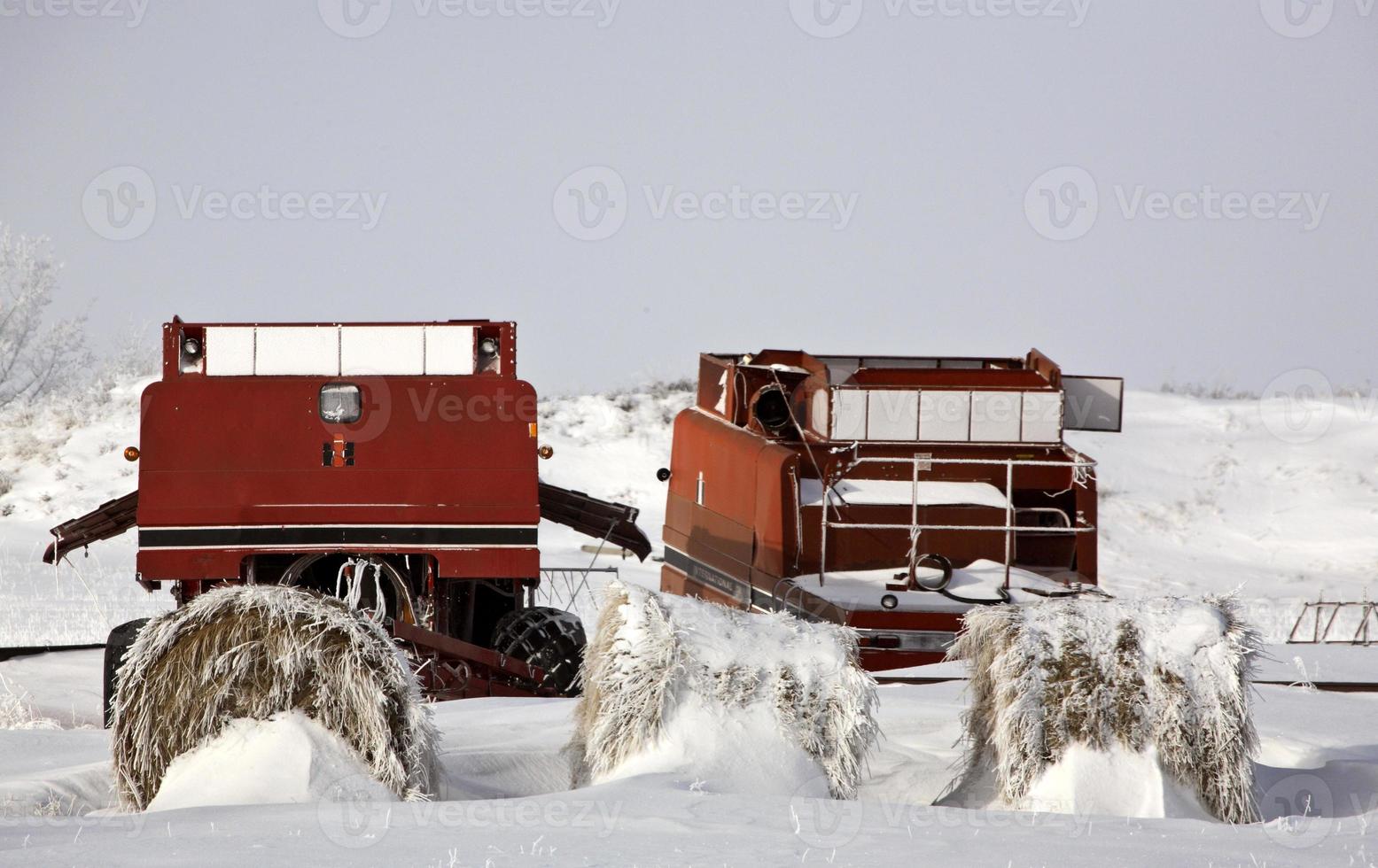 Two abandoned old combines in winter photo