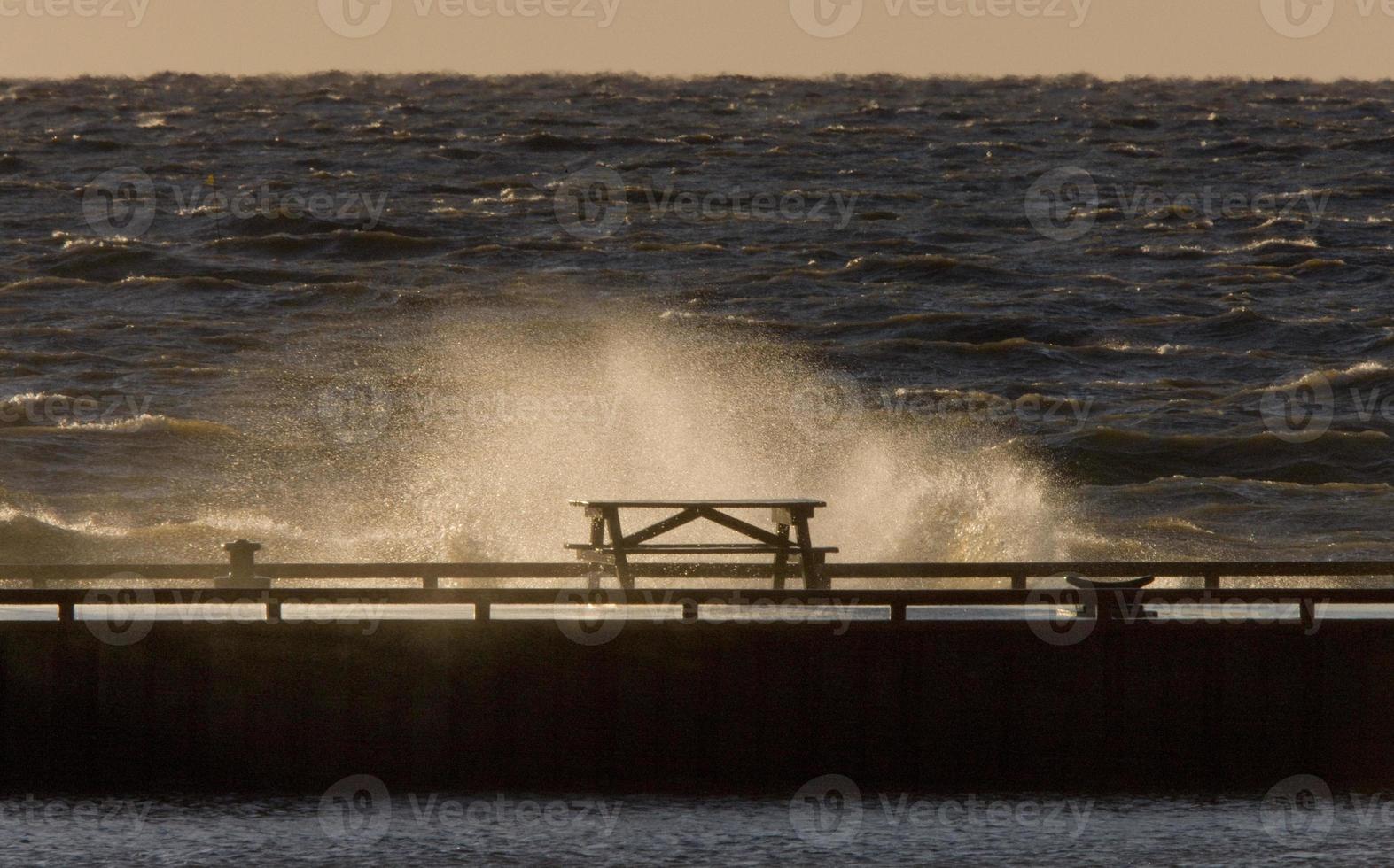 Waves crashing over pier Lake Winnipeg Manitoba photo