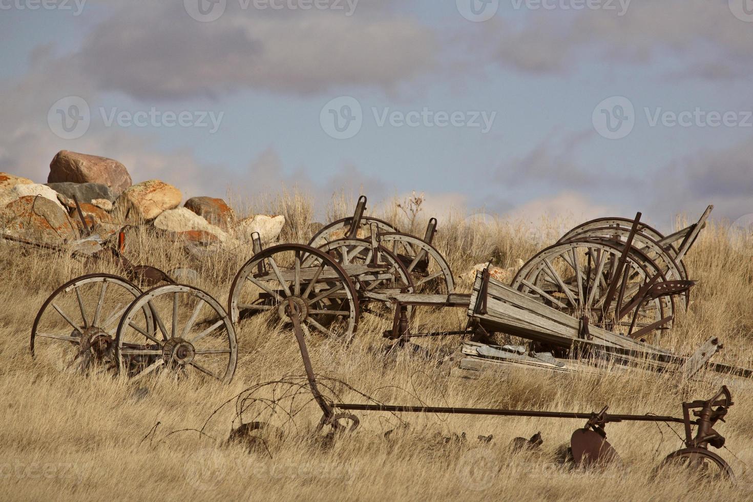 Old farm vehicle parts in winter photo