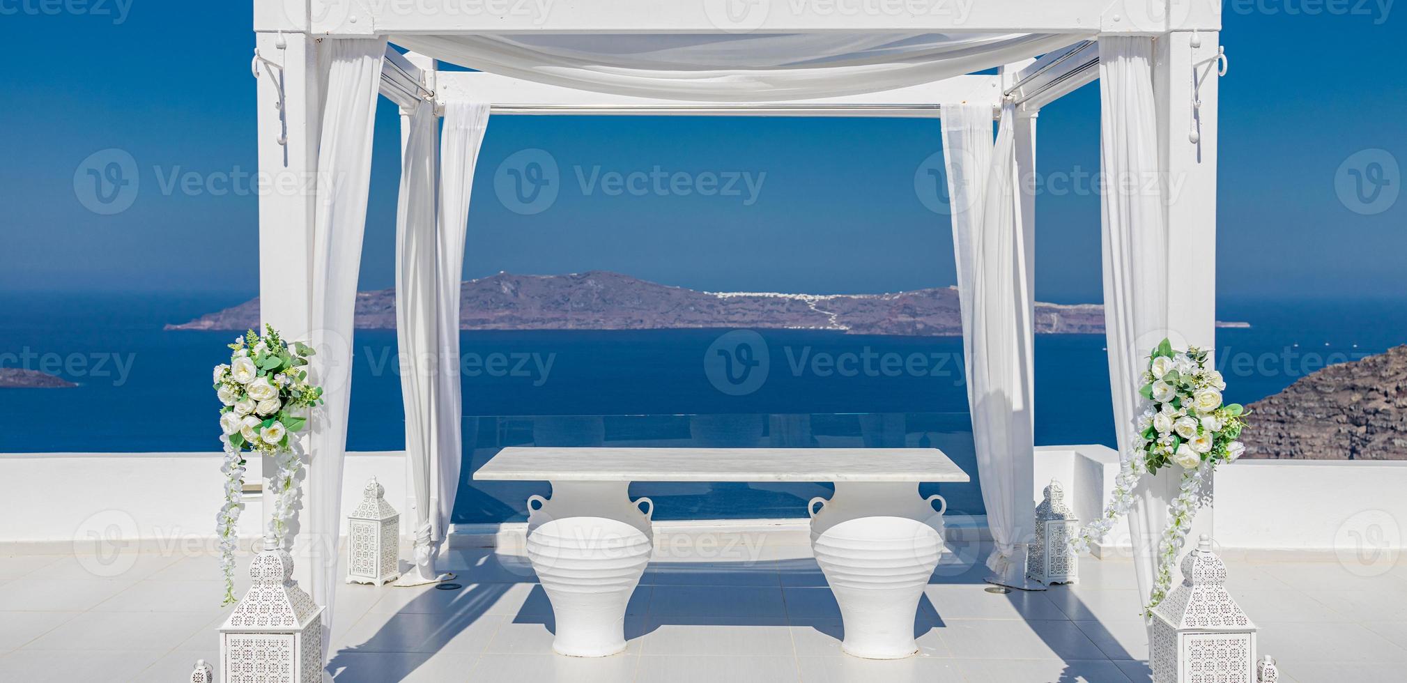 Beautiful wedding tent on Santorini island. Wedding decorations with roses on the background of the sea, Greece, Santorini. Romantic destination wedding, romance concept photo