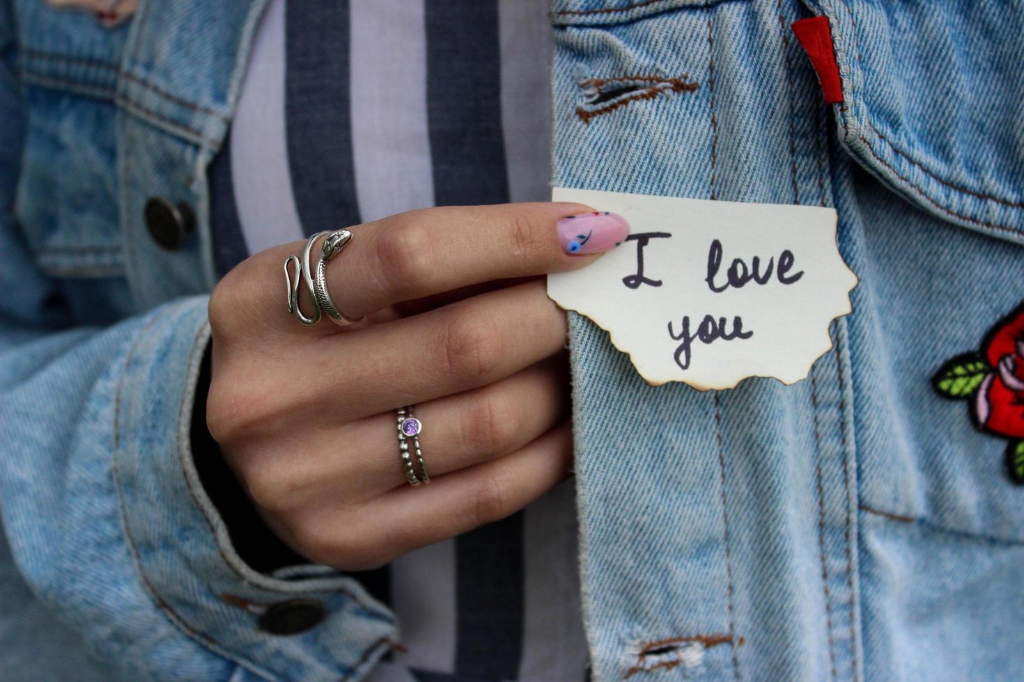 Girl in a jeans jacket with a declaration of love photo
