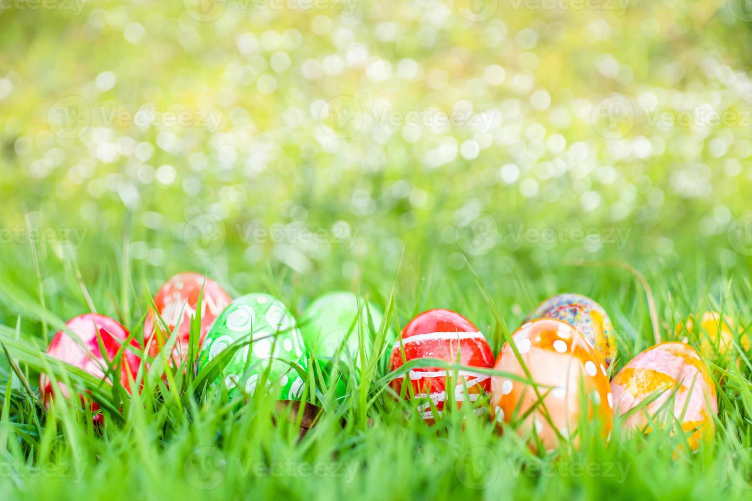 closeup, many beautiful painted easter eggs as grass blurred background. concept for good friday, easter monday, spring full moon. copy space on top for text or design. garden, nobody, selective focus photo