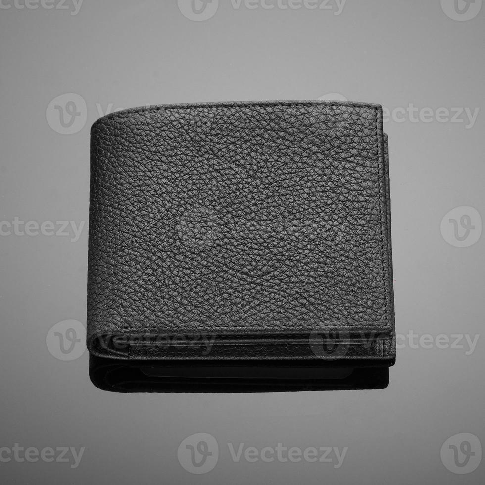 Fashionable designer leather men's wallet on a black background photo