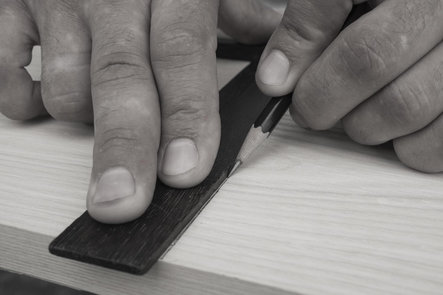 The joiner marks the workpiece with a pencil. joinery photo