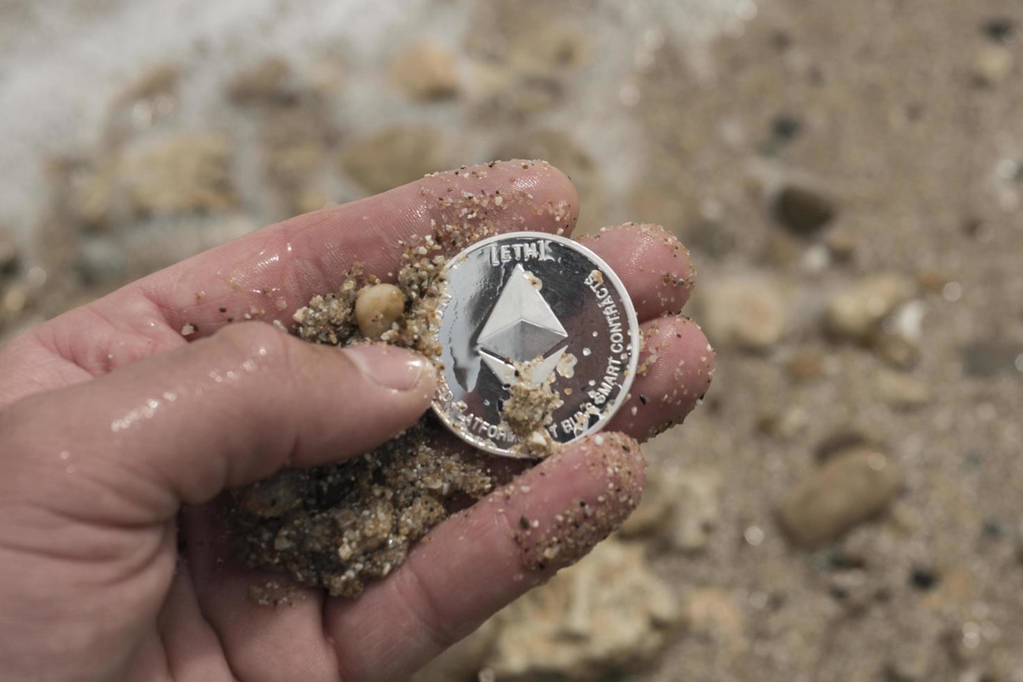 ethereum Cryptocurrency. e-currency. sea. ethereum in hand photo