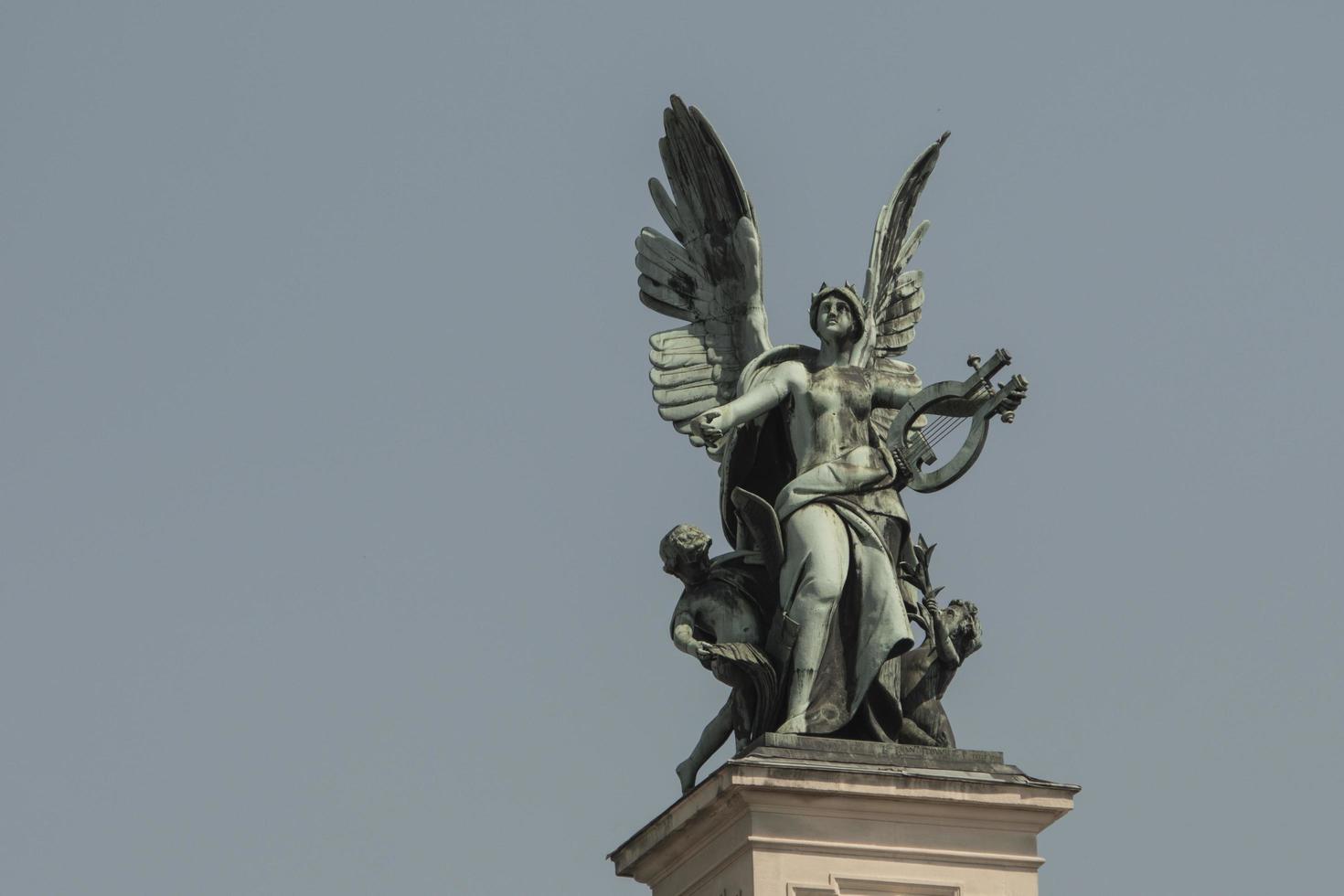 bronze sculpture genius with wings on the roof of the opera house in Lvov photo
