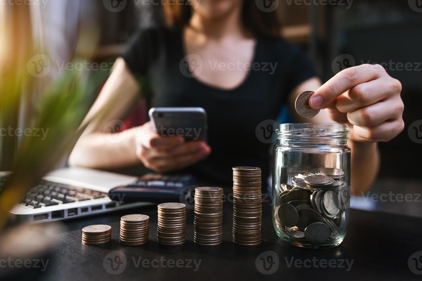 Business accountant working on desk using mobile phone and calculator to calculate budget concept finance and accounting photo