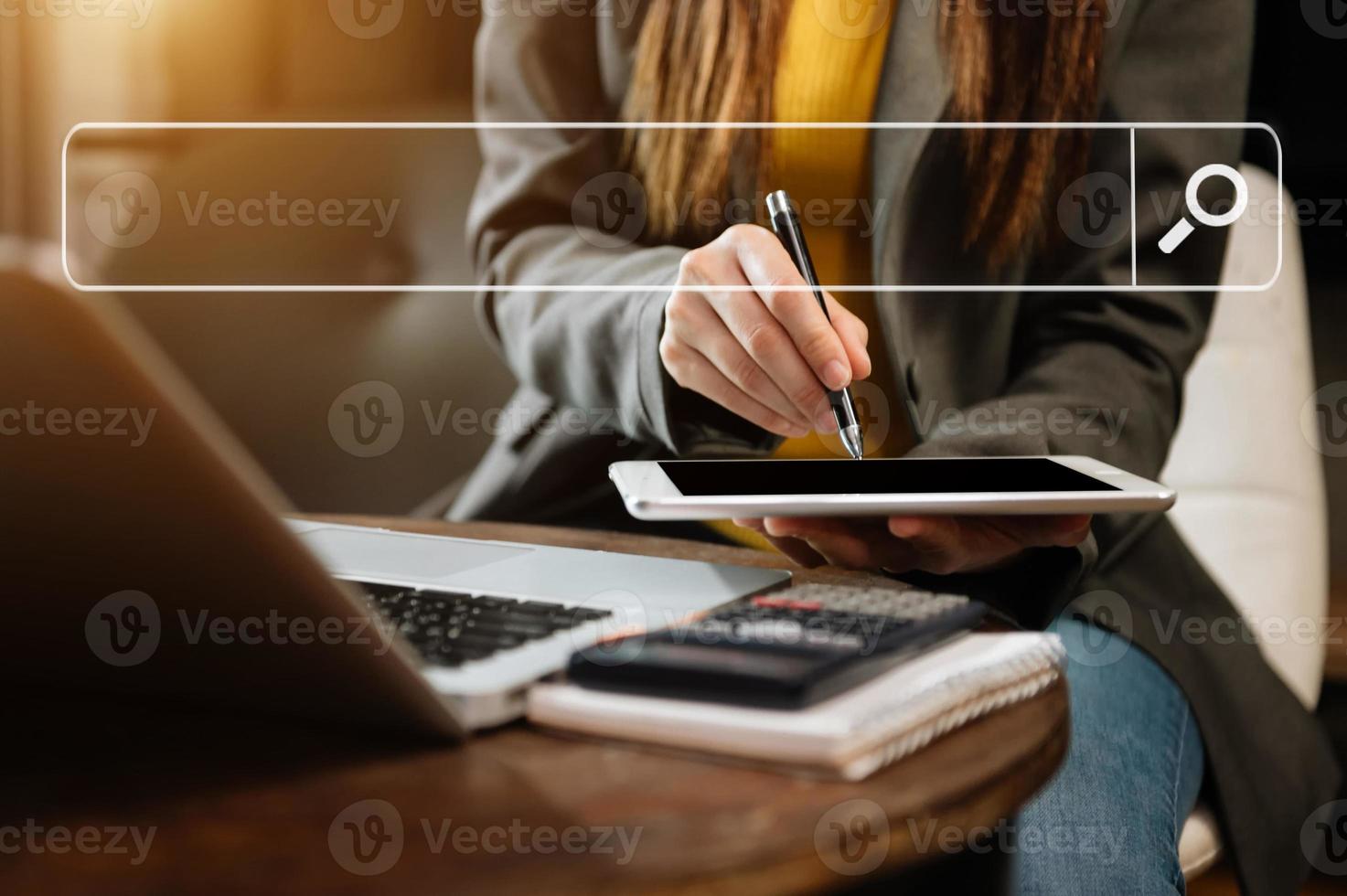 businesswoman working with mobile phone and laptop computer VR icon in office photo