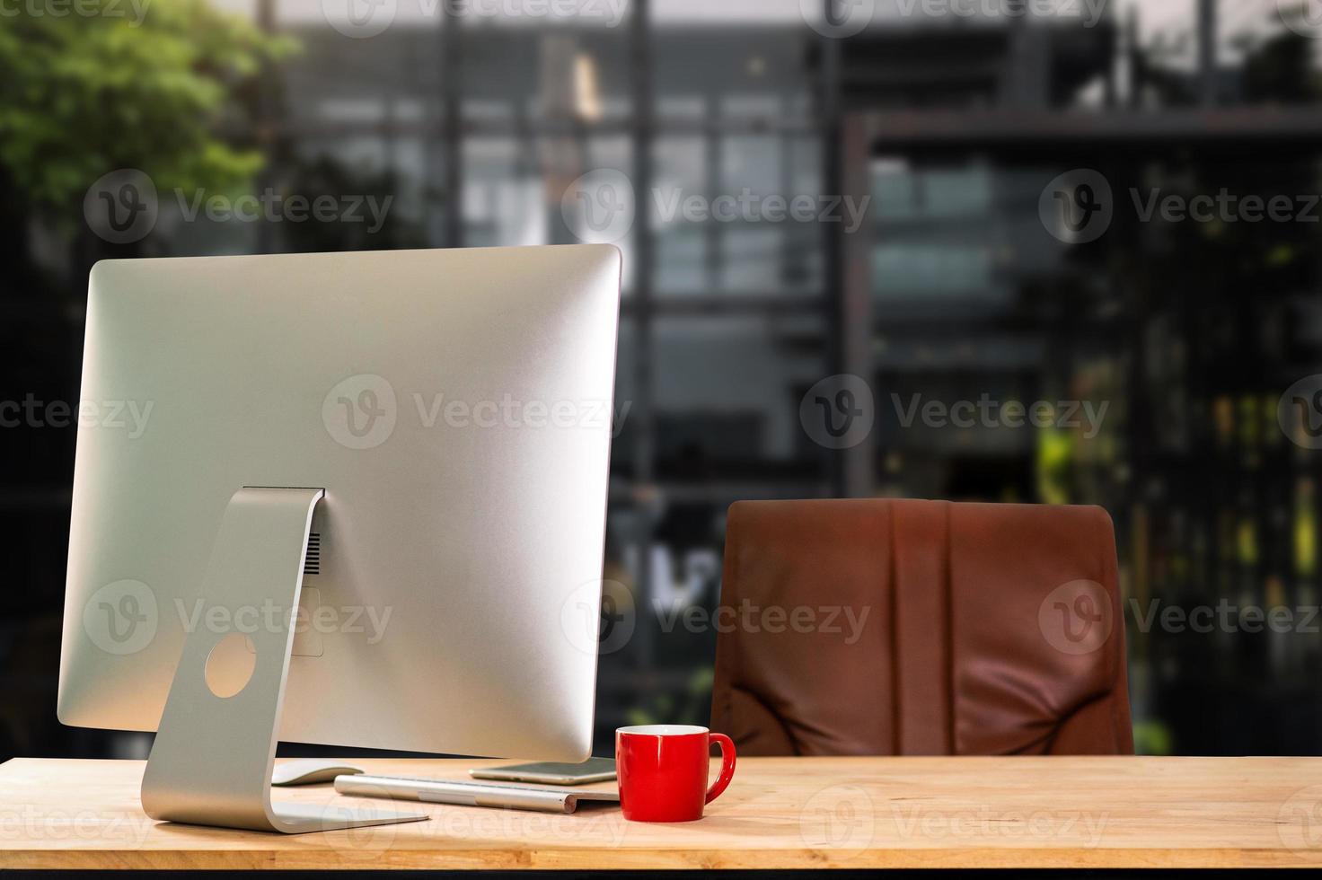Computer Monitor, Keyboard, coffee cup smartphone, tablet, and Mouse with Blank or White Screen Isolated is on the work table in the coffeeshop photo