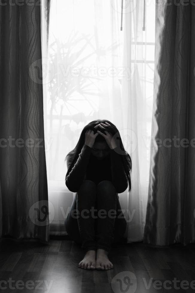 woman sit Depression Standing by window and anxiety Copy space. photo