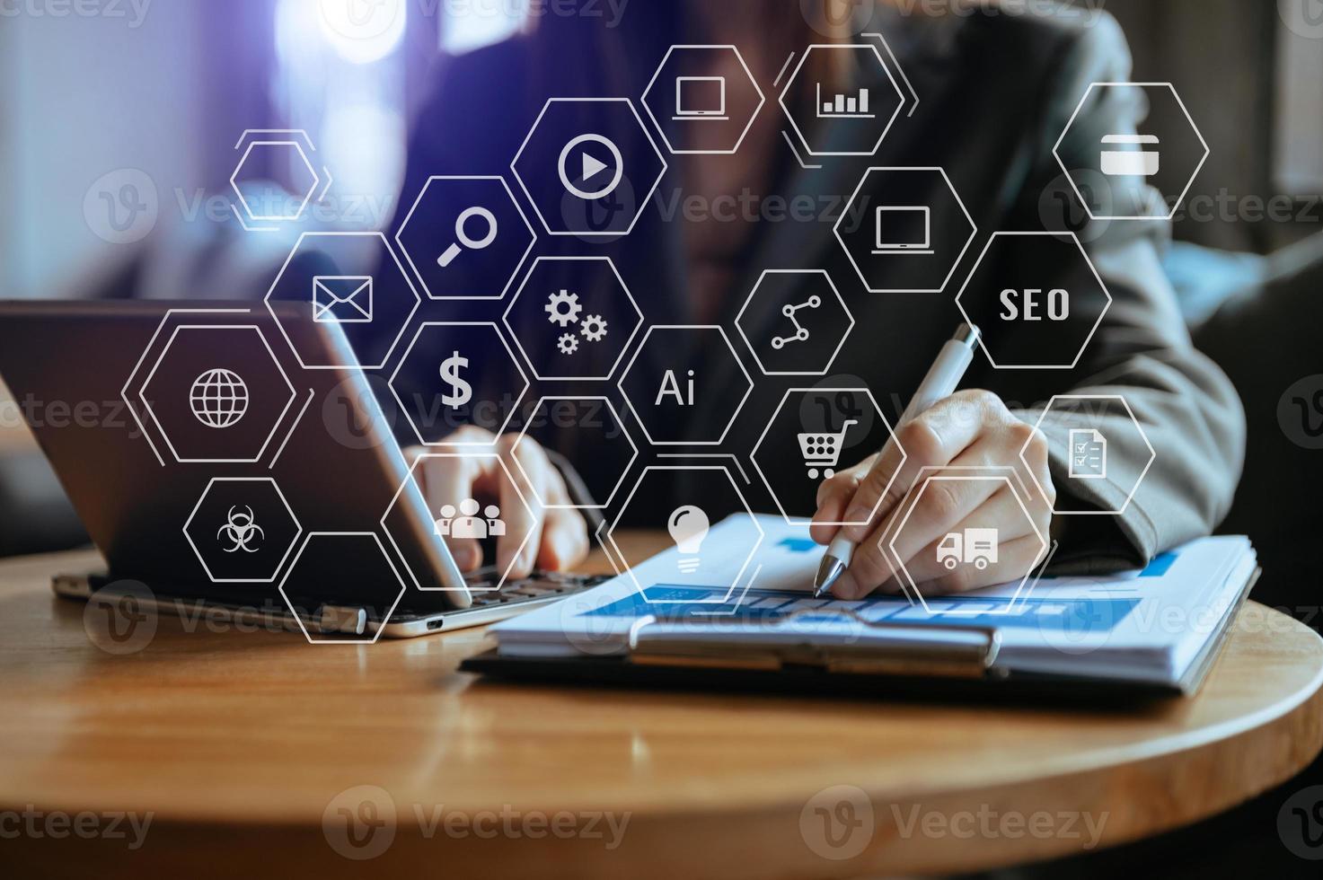 Businesswoman using mobile phone and laptop computer on white desk big data analytics with business intelligence concept. photo