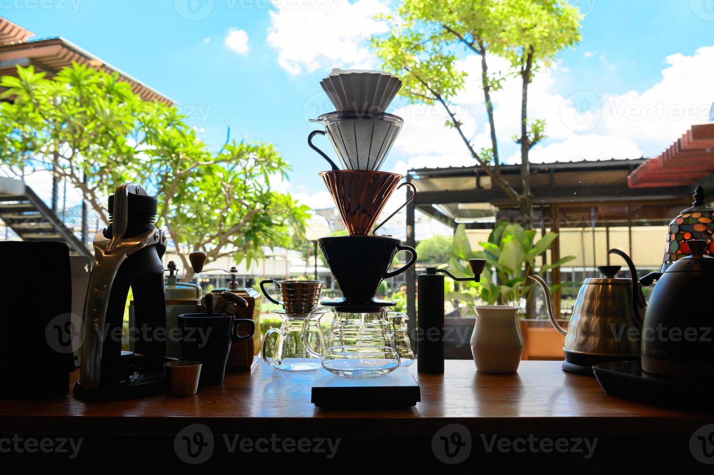 Barista experimenting with new flavors of drip coffee by stacking the dripper like a tower. photo